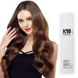 Woman with voluminous hair holding hair next to K18 Mask bottle – 150ml