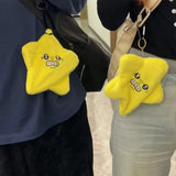 Jumping angry star plush toys clipped to shoulder bags while worn by two people