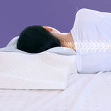 Woman using ergonomic memory foam butterfly pillow with aligned cervical spine for side sleeping
