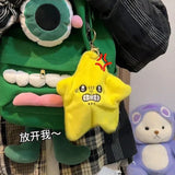 Angry star plush toy hanging from green monster-themed backpack