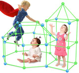 Three children playing inside a DIY fort made of green rods and colorful connectors