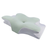 Mint green and white ergonomic foam pillow with soft contours for improved sleep posture