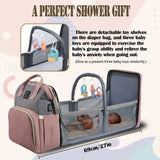 Foldable travel crib extended from diaper bag with toy arch and breathable mesh sides, 27-inch length.