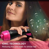 Woman using ionic hair dryer brush to reduce frizz and static for shinier hair