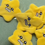 Pile of yellow angry star plush toys with expressive cartoon faces