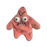 Pink starfish-shaped plush toy with bulging eyes and angry expression