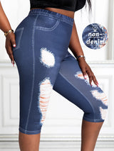 Close-up side view of plus size faux denim print capri pants with distressed detail and stretchy knit fabric – non-denim material