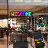 Programmable RGB LED matrix display in café window showing “FOOD” – ideal for business advertising and storefront signage