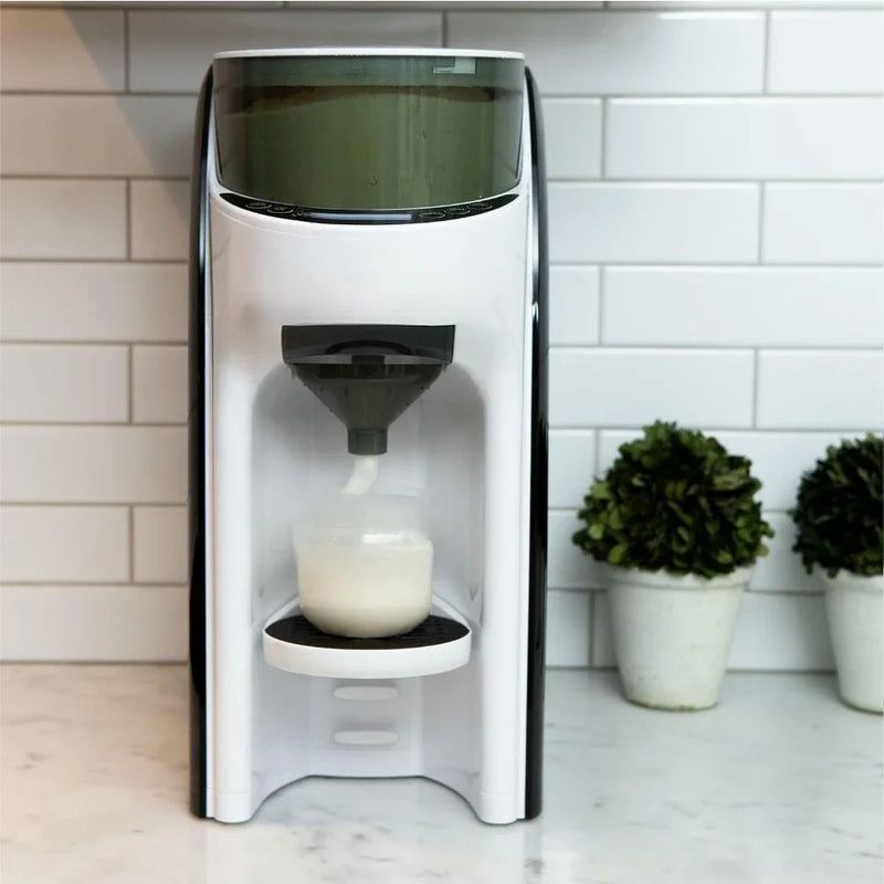 Countertop formula dispenser pouring warm formula into a baby bottle.