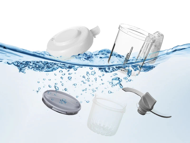 Removable parts—lid, jug, steam basket and blade—submerged to show dishwasher-safe, easy-to-clean design.