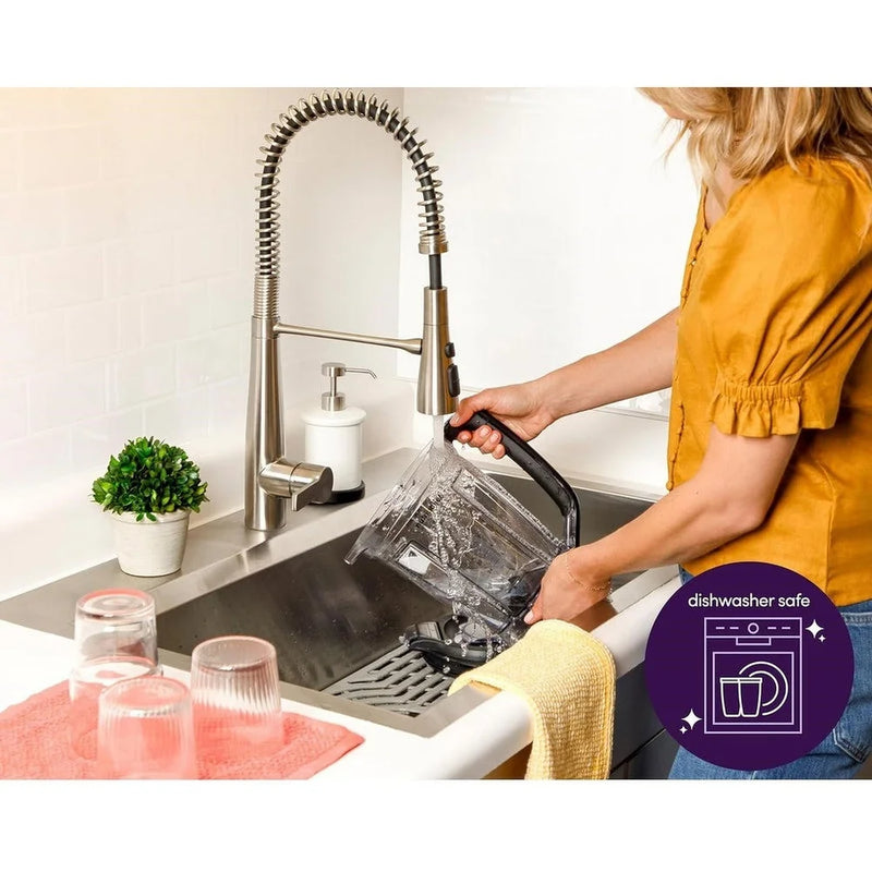 Rinsing blender pitcher at the sink; removable parts are dishwasher safe