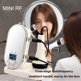 Mini RF & EMS radio frequency skin tightening machine with face probe next to mirror