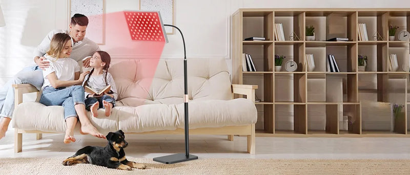  Family relaxing while using red light therapy panel in living room