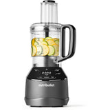 Food processor attachment on blender base chopping vegetables and nuts