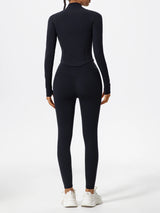 Back view of black Hearuisavy yoga jacket with curved seam detail and long sleeves