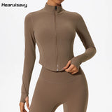 Woman wearing brown Hearuisavy slim-fit yoga jacket with zipper front and thumbholes