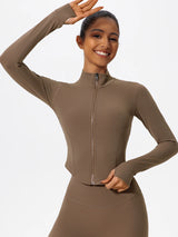 Smiling model wearing brown Hearuisavy zip-up yoga jacket with thumbholes