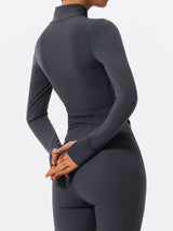 Side view of dark blue Hearuisavy yoga jacket showing long sleeves and thumbholes