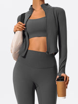 Woman in gray Hearuisavy yoga jacket holding coffee cup and shoulder bag