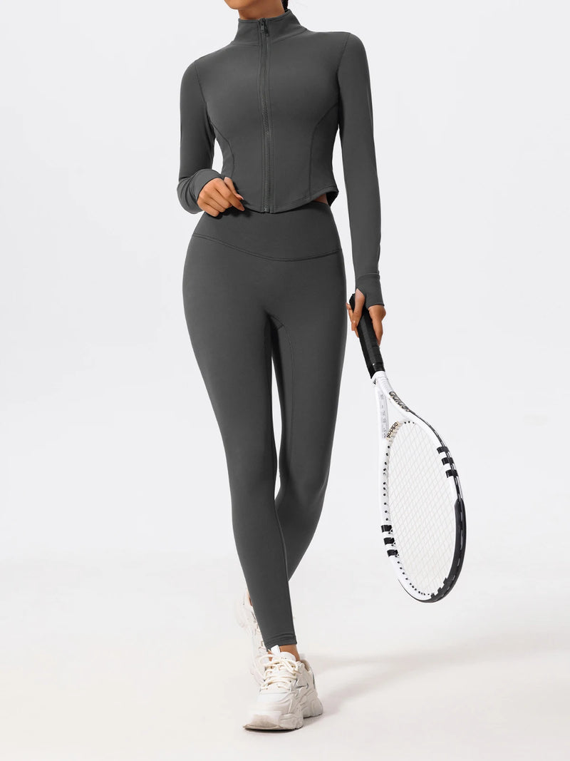 Full-body image of woman in gray Hearuisavy yoga jacket holding tennis racket