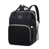 ck mommy diaper backpack with gold-tone zipper trim, top handles, padded straps, and side USB charging port, front three-quarter view.