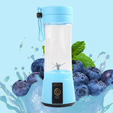 Blue USB rechargeable blender with six-blade head in front of blueberries and splash graphic