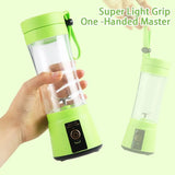 One-hand grip demo of green mini blender with carry loop and power button