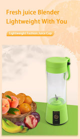 Green mini smoothie blender on counter with basket of fruit