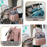 Diaper backpack clipped to stroller with removable buckles and worn as a backpack for hands-free carrying.