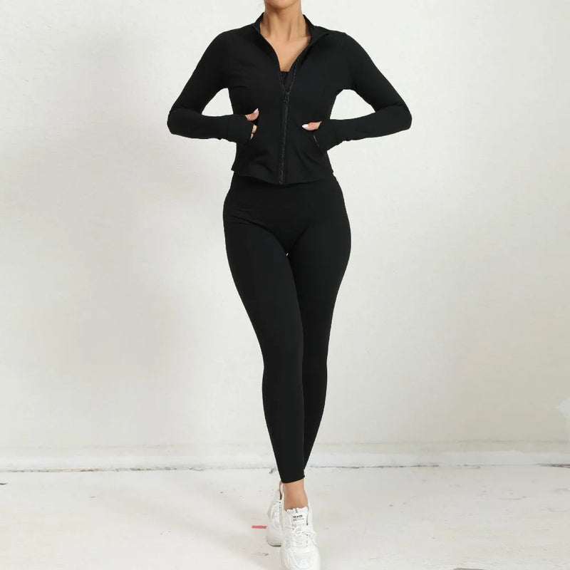 Black long-sleeve activewear zip jacket and leggings outfit for yoga or gym wear.