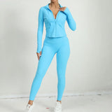 Light blue women’s yoga set with zip-up jacket and matching leggings, athletic front pose.