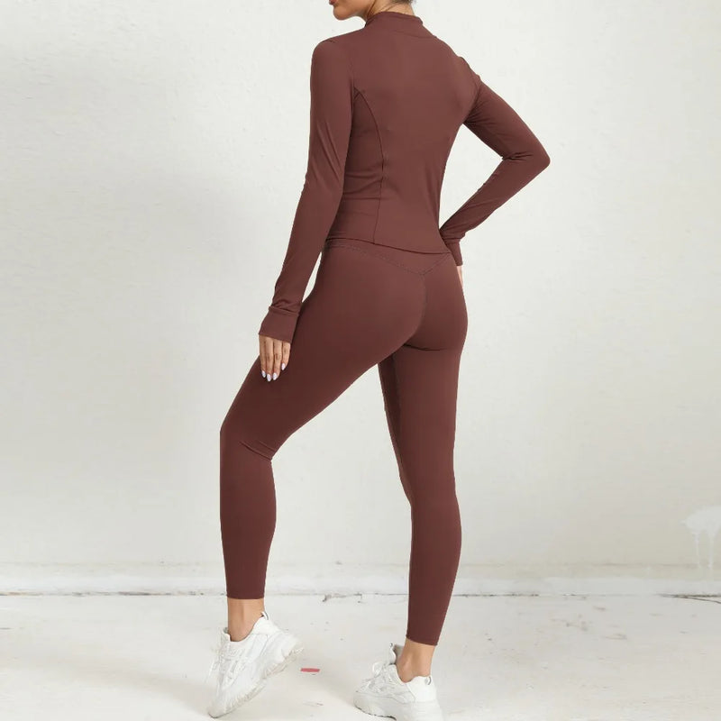 Back view of brown 2-piece yoga outfit featuring long-sleeve zip jacket and leggings.