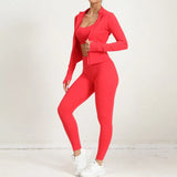 Red 2-piece yoga set with open zip jacket and leggings, side angle pose.