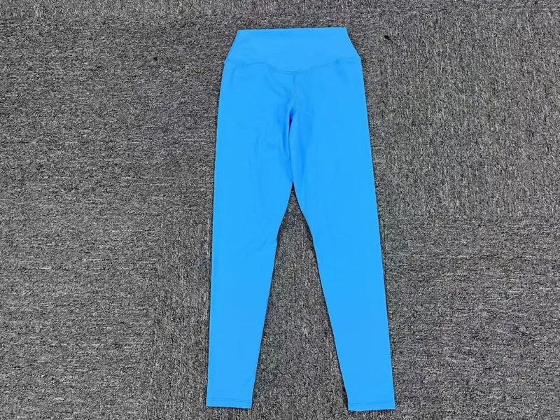 Blue high-waist leggings flat lay on gray background, part of women’s yoga outfit set.