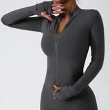 Woman in dark gray long sleeve zip fitness jacket for yoga or gym workouts